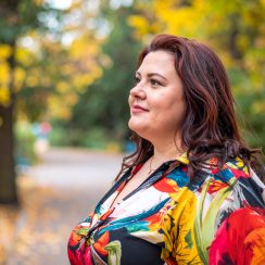 Firefly create a profile picture of a large woman wearing colorful clothes. heer background is a par Firefly create a profile picture of a large woman wearing colorful clothes. heer background is a par