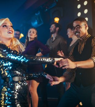 Young man and woman enjoying a night out at the club