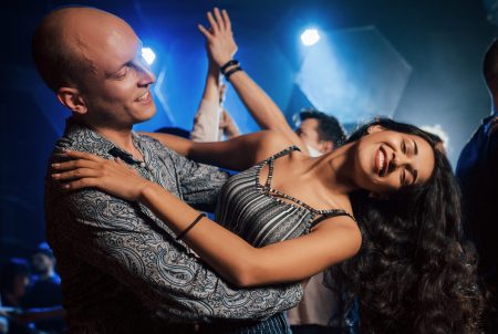 Professional moves. Couple dancing at nightime in the club. Enjoying music and each other.